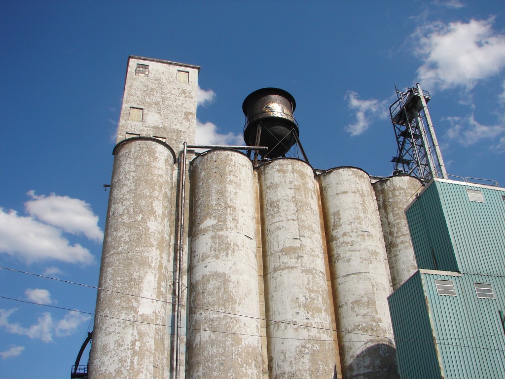 Looking up at the Archer Daniels Midland Plant in Chicago with blue sky behind it