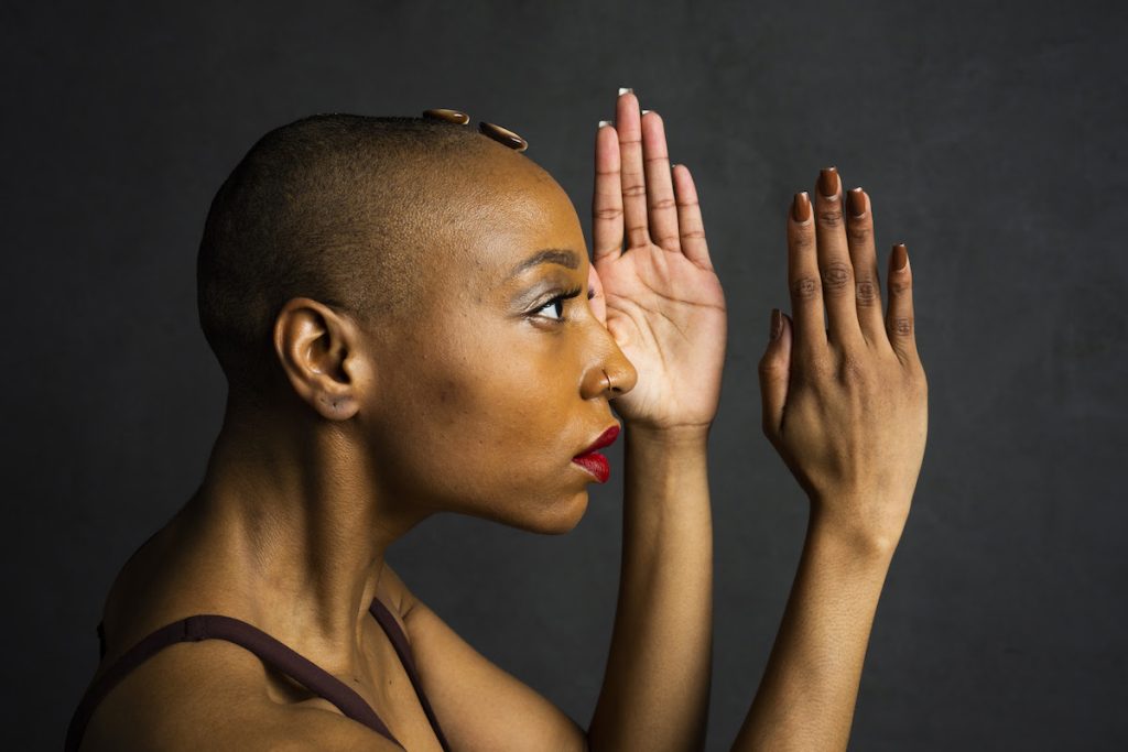 Photo of dancer looking out to the side with arms held out in front