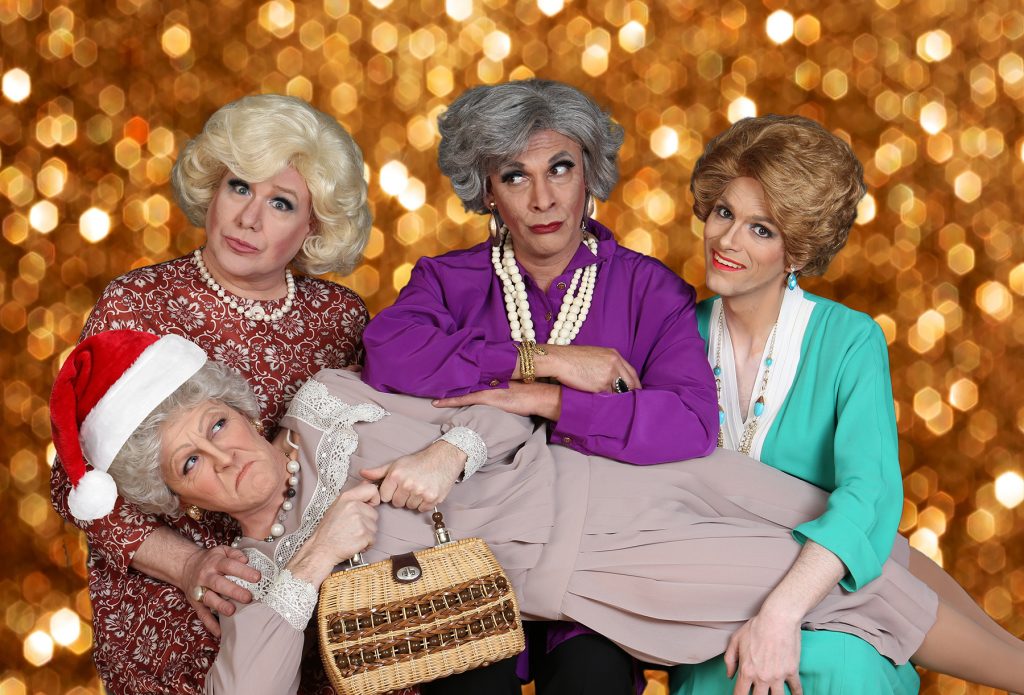 Actors dressed as the Golden Girls main cast in front of glittery gold backdrop