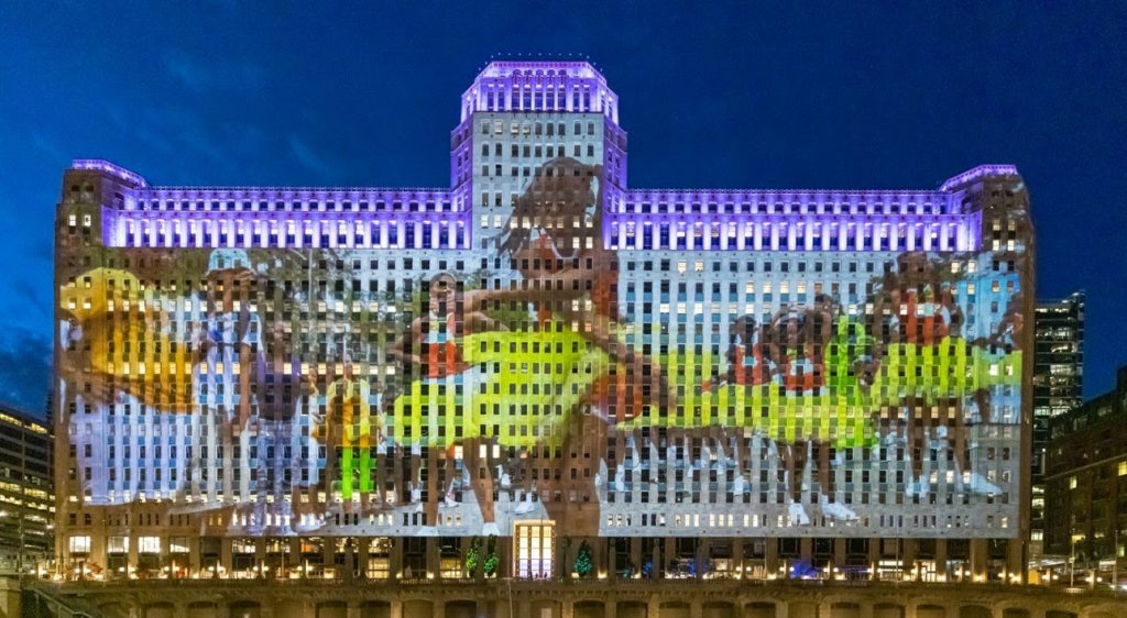 Photo of dancers projected on the facade of the Merchandise Mart.