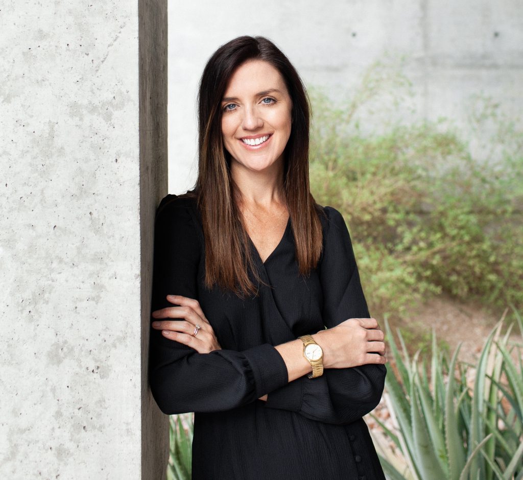 Photo portrait of woman in black shirt smiling.